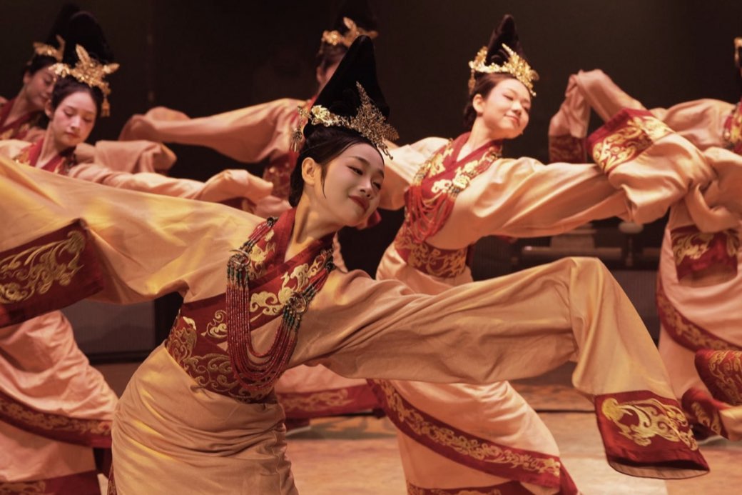 Dancers close, sleeves and gold headdresses