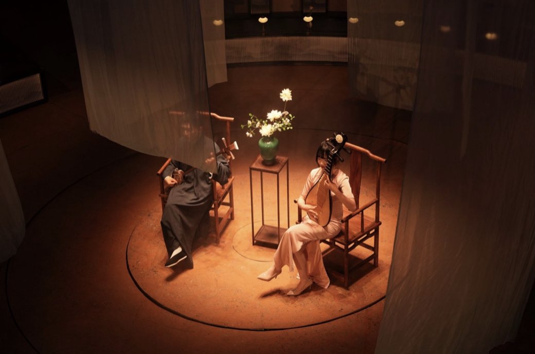 The stage set with two chairs behind hanging gauze