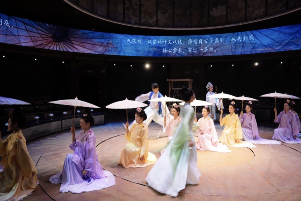 Performers in motion under the projection band