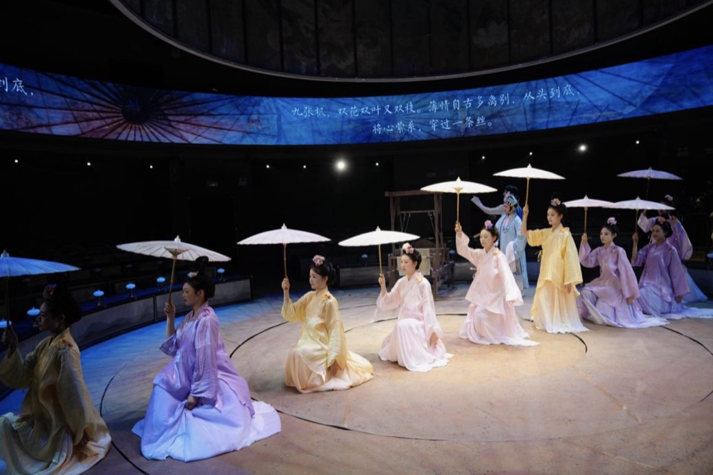 Parasols and pale hanfu beneath a painted sky